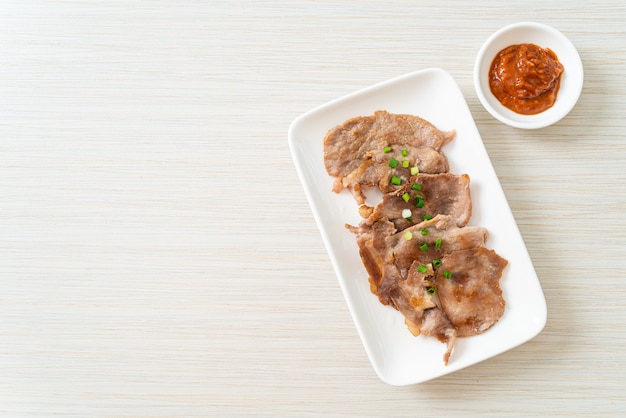 grilled pork neck sliced on plate in Asian style