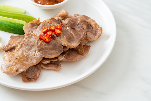 grilled pork neck sliced on plate in Asian style