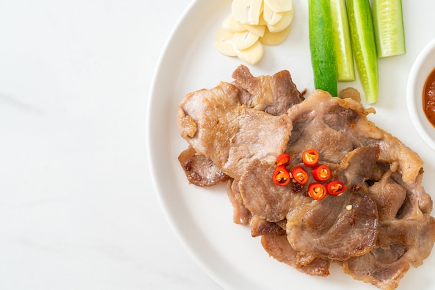 grilled pork neck sliced on plate in Asian style