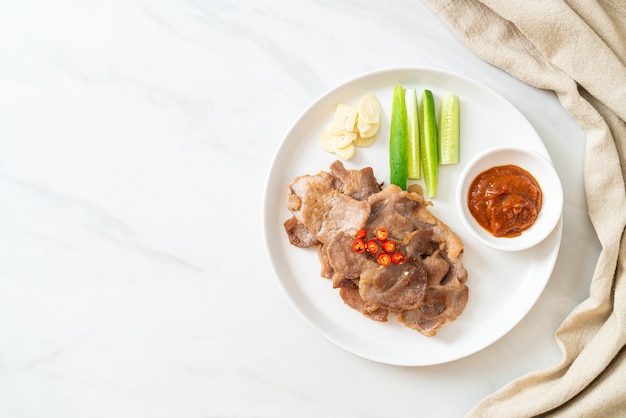 grilled pork neck sliced on plate in Asian style