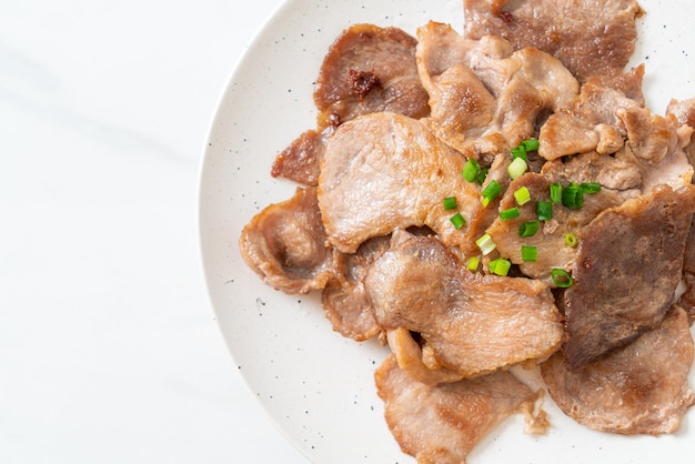 grilled pork neck sliced on plate in Asian style