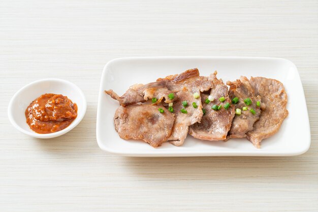 Grilled pork neck sliced on plate in Asian style