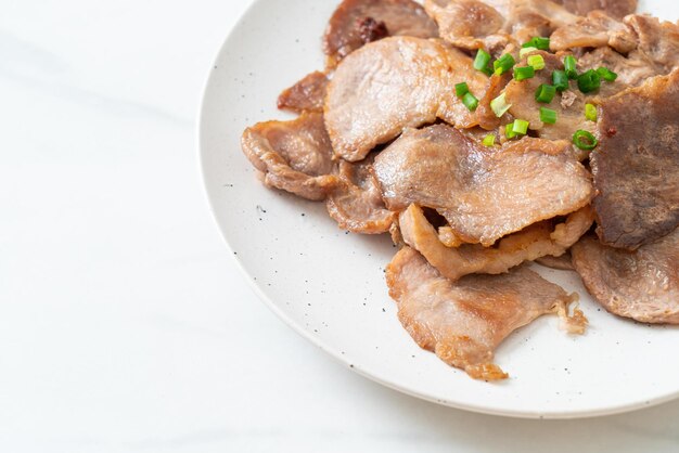 grilled pork neck sliced on plate in Asian style