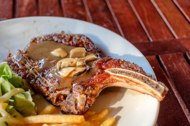 Grilled pork ribs steak welldone with french fries and vegetable