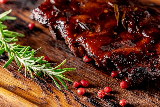 Grilled pork ribs with barbecue sauce on a wooden board