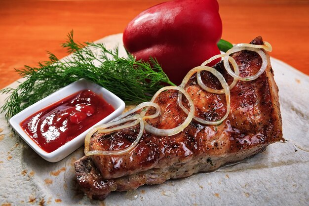 Grilled pork ribs with onions and barbecue sauce