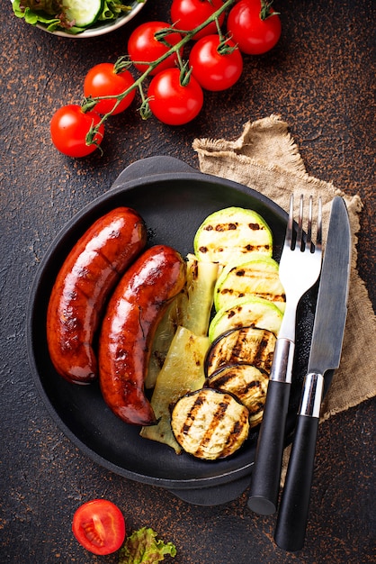 Grilled pork sausages and vegetables