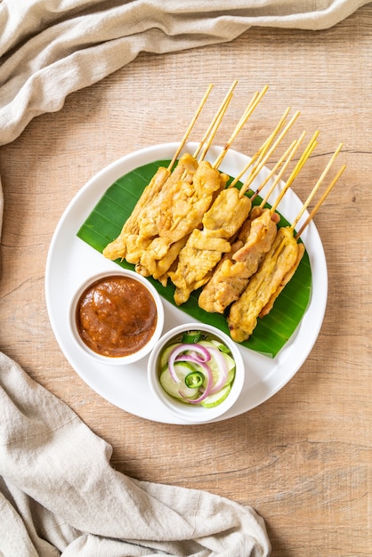 Grilled pork served with peanut sauce and sour sauce