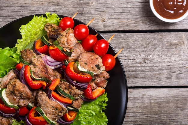 grilled pork shish or kebab on skewers with vegetables food background shashlik