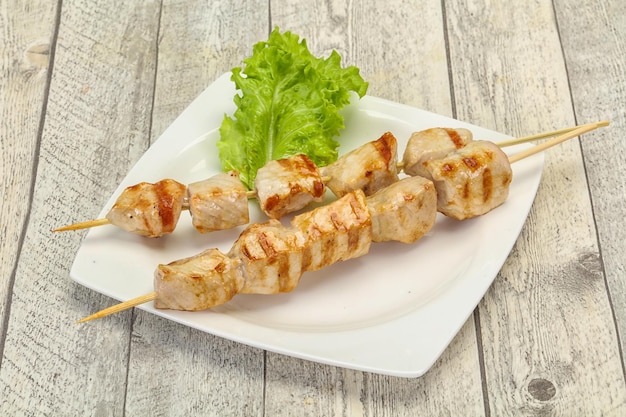 Grilled pork skewer served salad