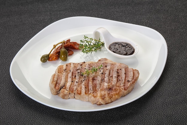 Grilled pork steak with pepper sauce