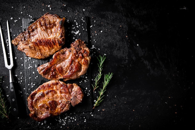 Grilled pork steak with a sprig of rosemary