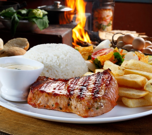 Grilled pork with fries and vegetables