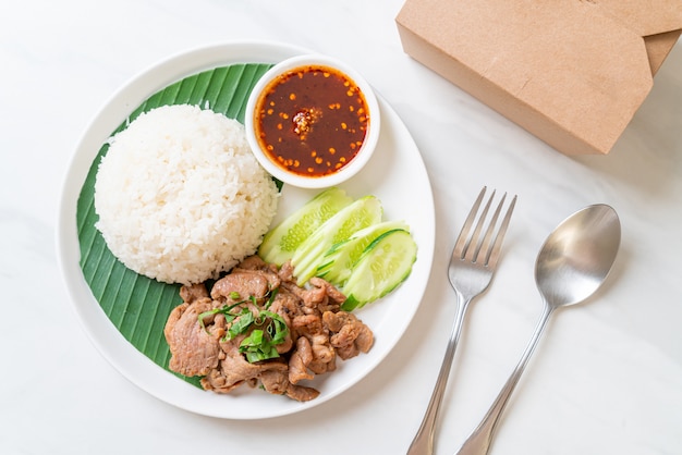 Grilled pork with rice and spicy sauce in Asian style