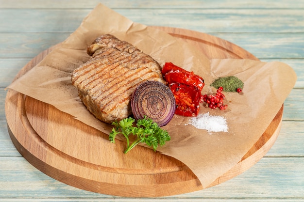 Grilled pork with vegetables on parchment paper