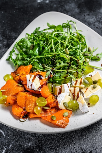 Grilled pumpking warm salad with arugula, walnuts and brie cheese