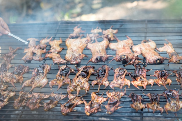 Grilled rat on grate grill, weird food concept.