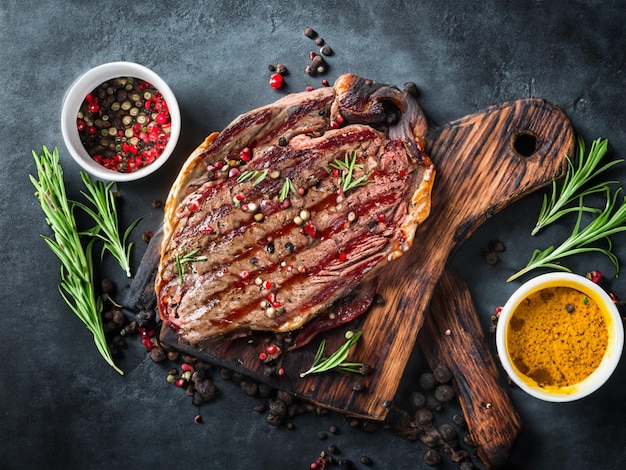 Grilled ribeye beef steak herbs and spices Top view with copy space for your text