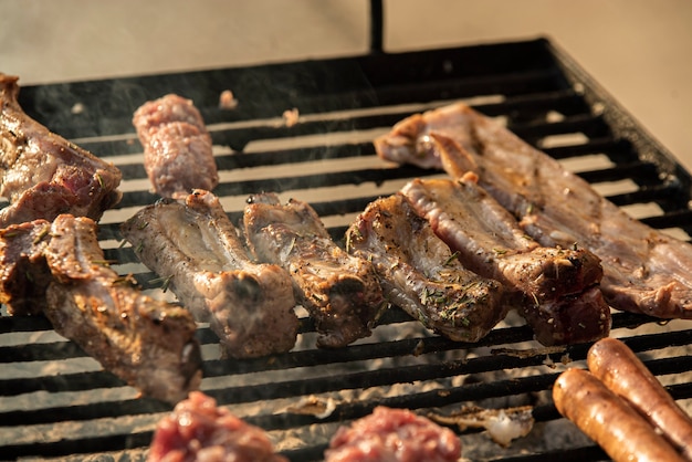 Grilled ribs detail on the grill with smoke cooking