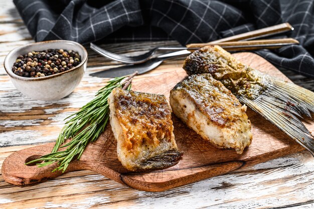 Grilled river fish silver carp on a cutting board