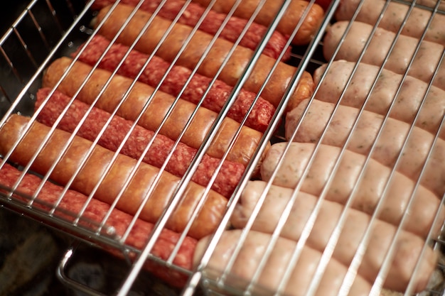 Grilled roast beef and lamb sausages on bbq grid