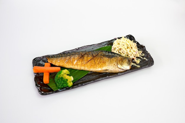 Grilled saba fish with soy sauce and salt with vegetable on dish