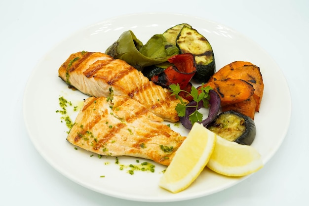 Grilled salmon accompanied by roasted vegetables