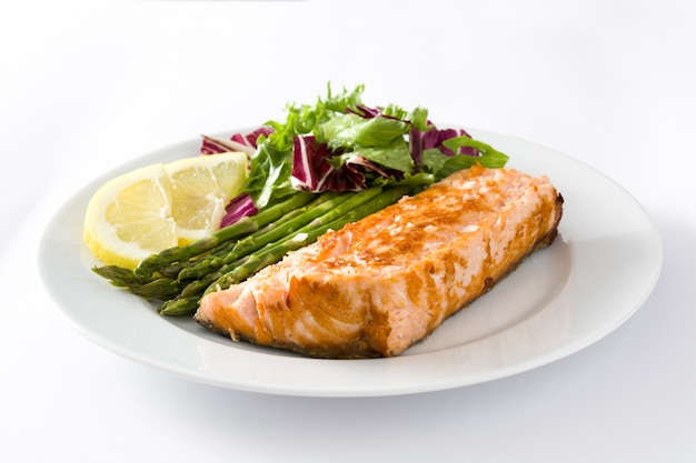 Grilled salmon fillet with asparagus and salad isolated on white