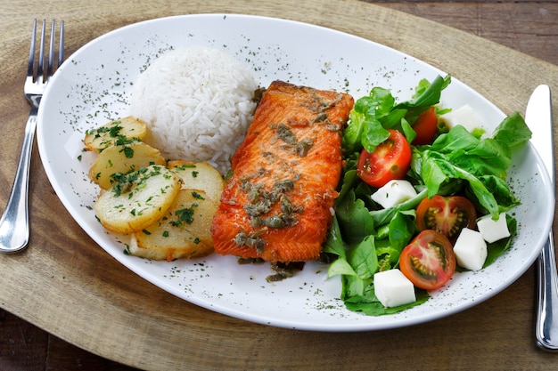 Grilled salmon fillet with potato rice and salad