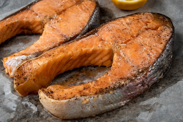 Grilled salmon fish on black background.