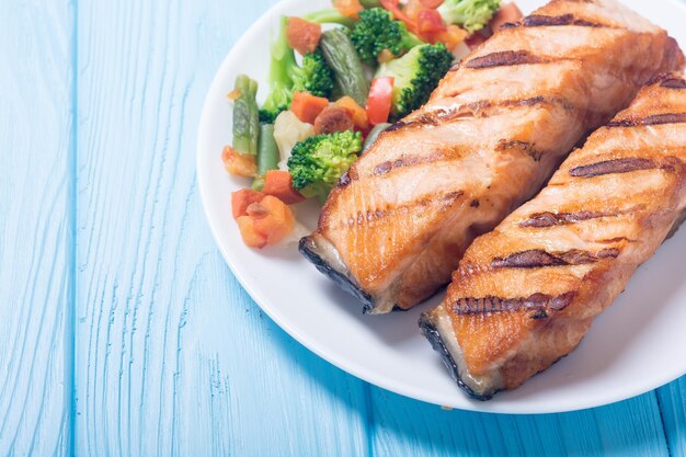 Grilled salmon fish on a plate with vegetables Seafood