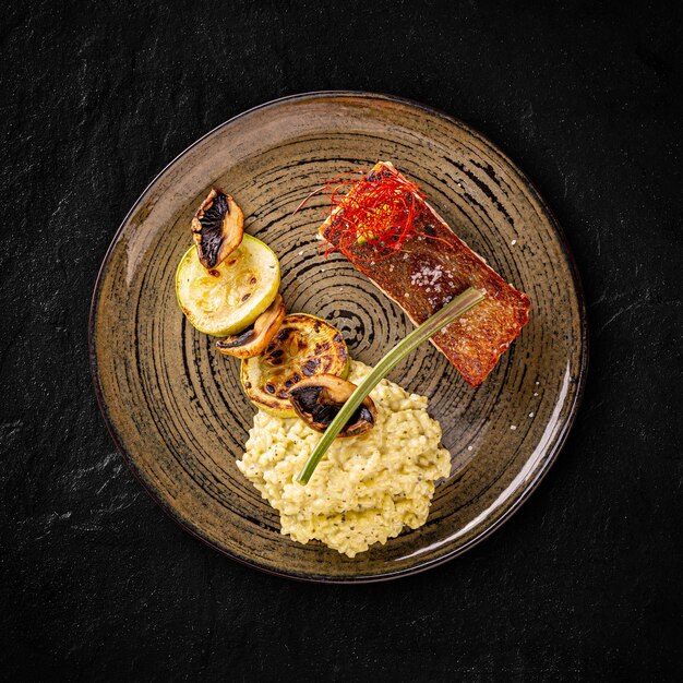 Grilled salmon served with risotto