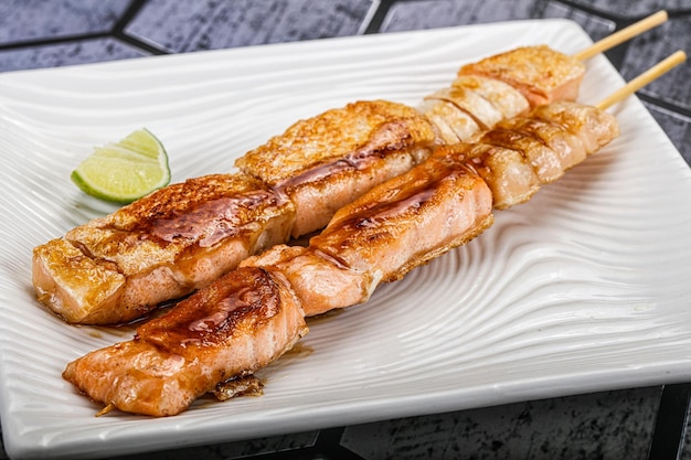 Grilled salmon skewer kebab with sauce