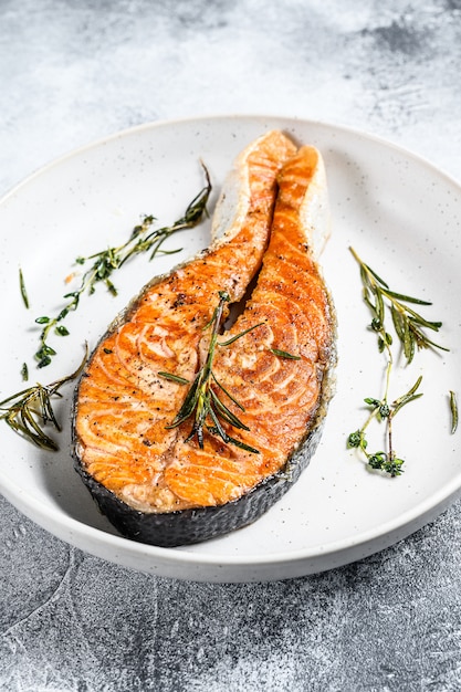 Grilled salmon steak. Atlantic fish. Gray background. Top view