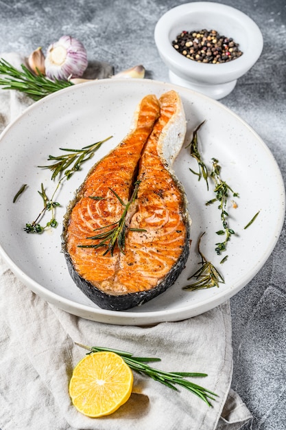 Grilled salmon steak. Atlantic fish. Gray wall. Top view