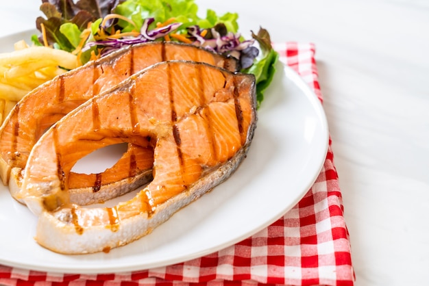 grilled salmon steak fillet with french fries