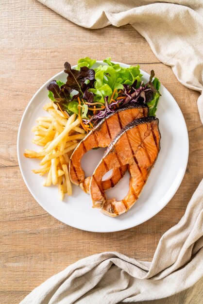 grilled salmon steak fillet with french fries