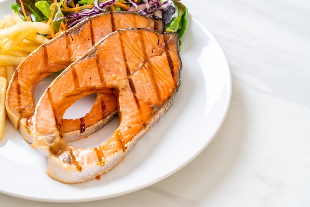 grilled salmon steak fillet with french fries