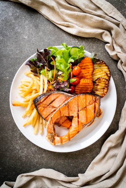 grilled salmon steak fillet with vegetable and french fries