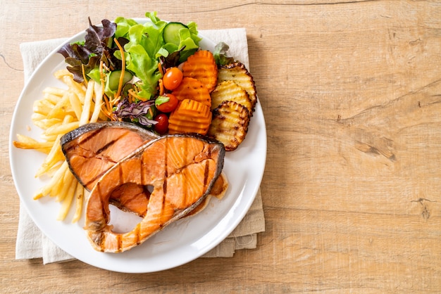 grilled salmon steak fillet with vegetable and french fries