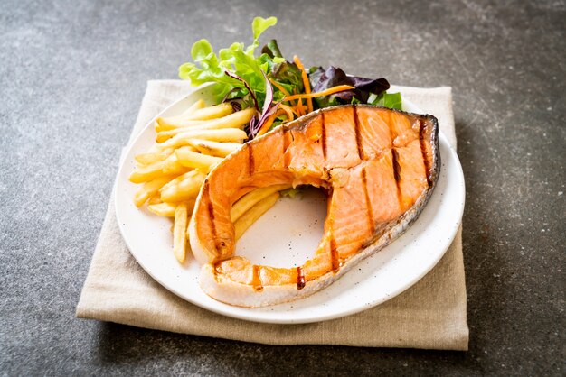 grilled salmon steak fillet with vegetable and french fries