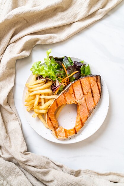 grilled salmon steak fillet with vegetable and french fries