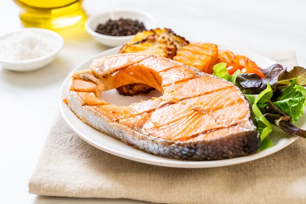 grilled salmon steak fillet with vegetable and french fries