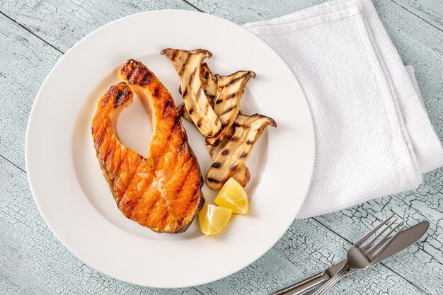 Grilled salmon steak garnished with fried eryngii mushrooms