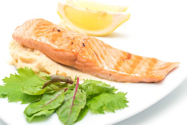 grilled salmon steak with mash potato and vegetable salad