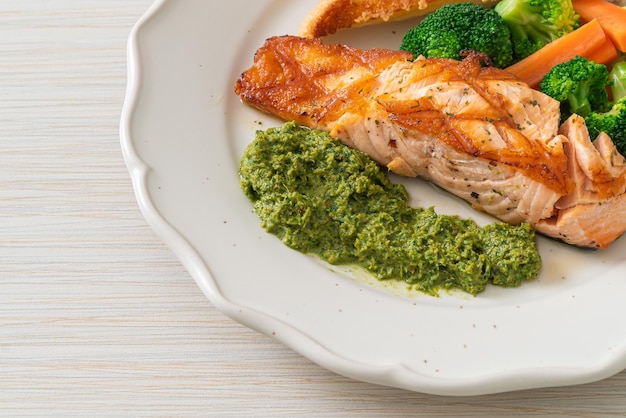 Grilled salmon steak with pesto sauce