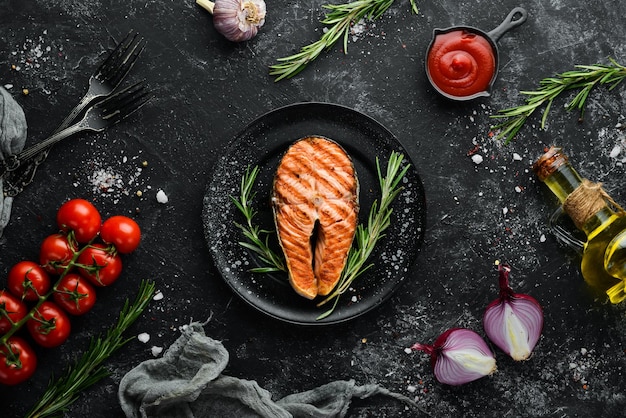 Grilled salmon steak with rosemary and spices Top view Free space for your text