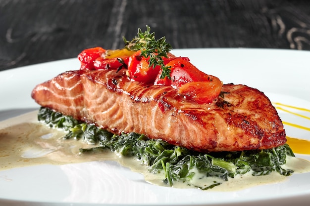 Grilled salmon steak with stewed spinach in cream