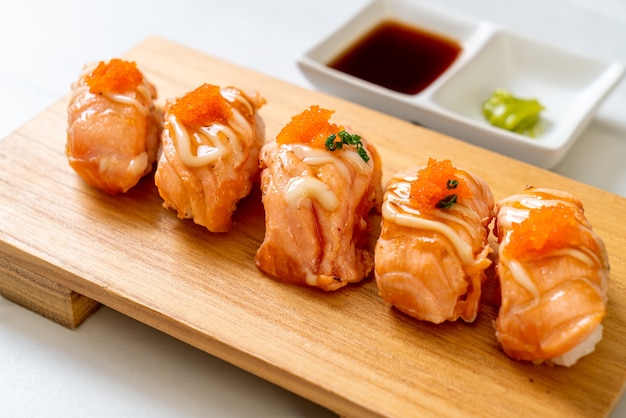 grilled salmon sushi on wood plate - Japanese food style