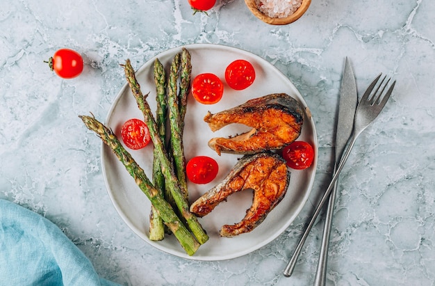 Grilled salmon with asparagus on gray marble background mediterranean diet concept